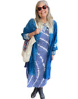 A woman wearing the Halley Linen Jacket over a dress.
