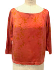 The red Lucia top naturally dyed floral print shown on a dress form, front view