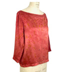 The red Lucia top naturally dyed floral print shown on a dress form, side view