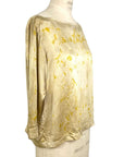 The yellow Lucia top naturally dyed floral print shown on a dress form, side view