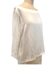 The white Lucia top shown on a dress form, side view