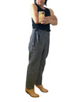 A woman wearing the black crop Nico pant, side view.