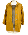 The sunrise jacket in yellow cotton linen fabric shown on a dress form, front view
