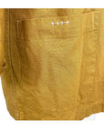 The sunrise jacket in yellow cotton linen fabric shown on a dress form, sashiko stitch detail