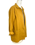 The sunrise jacket in yellow cotton linen fabric shown on a dress form, side view