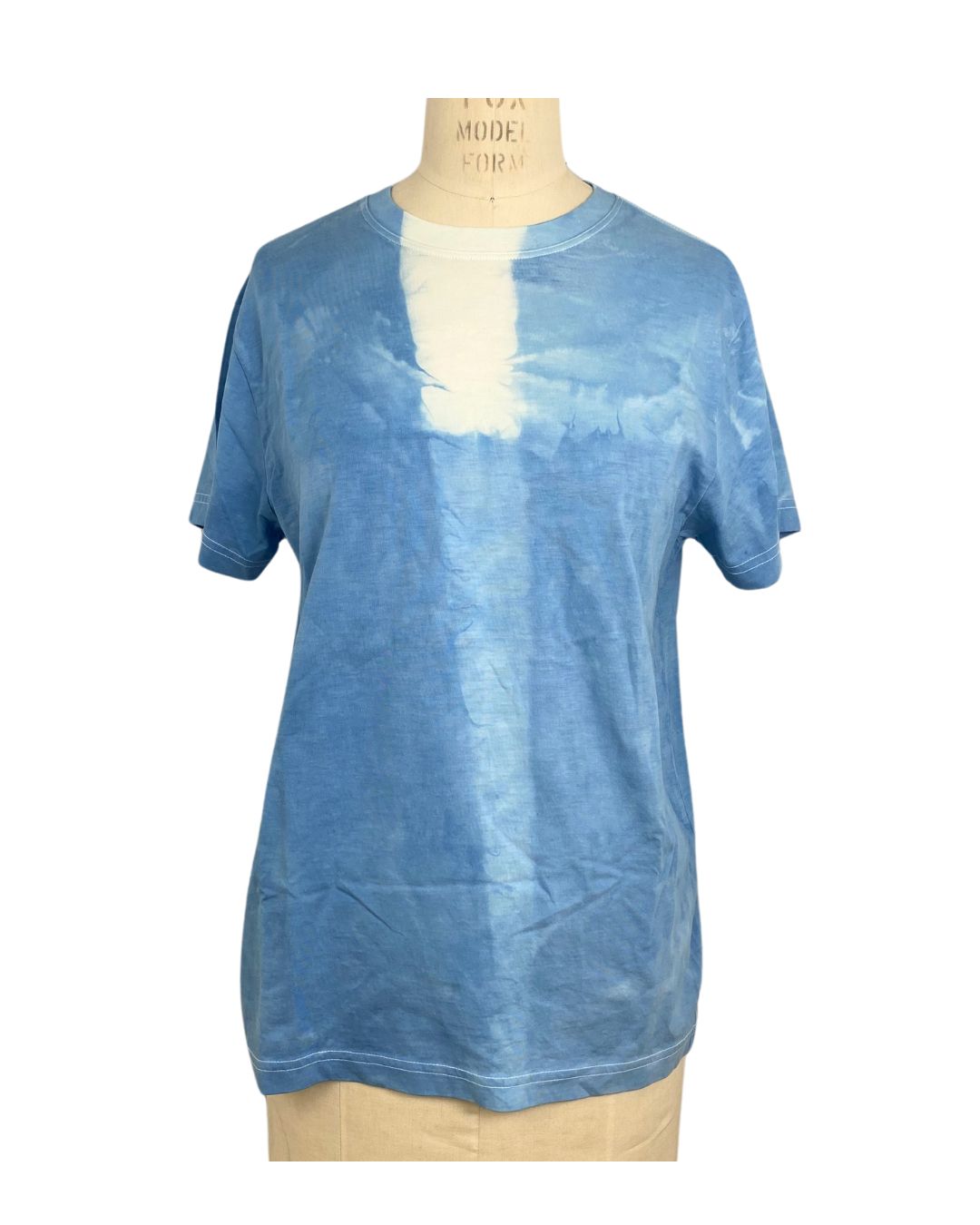 A beautiful blue hand dyed t shirt with a block front view.