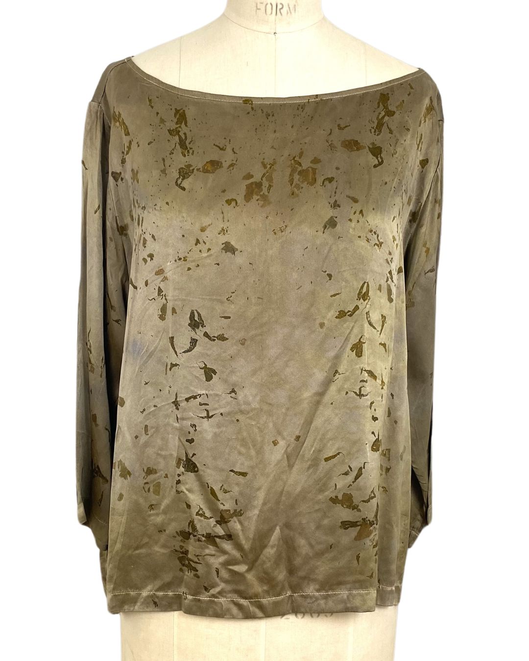 The olive green Lucia top naturally dyed floral print shown on a dress form, front view
