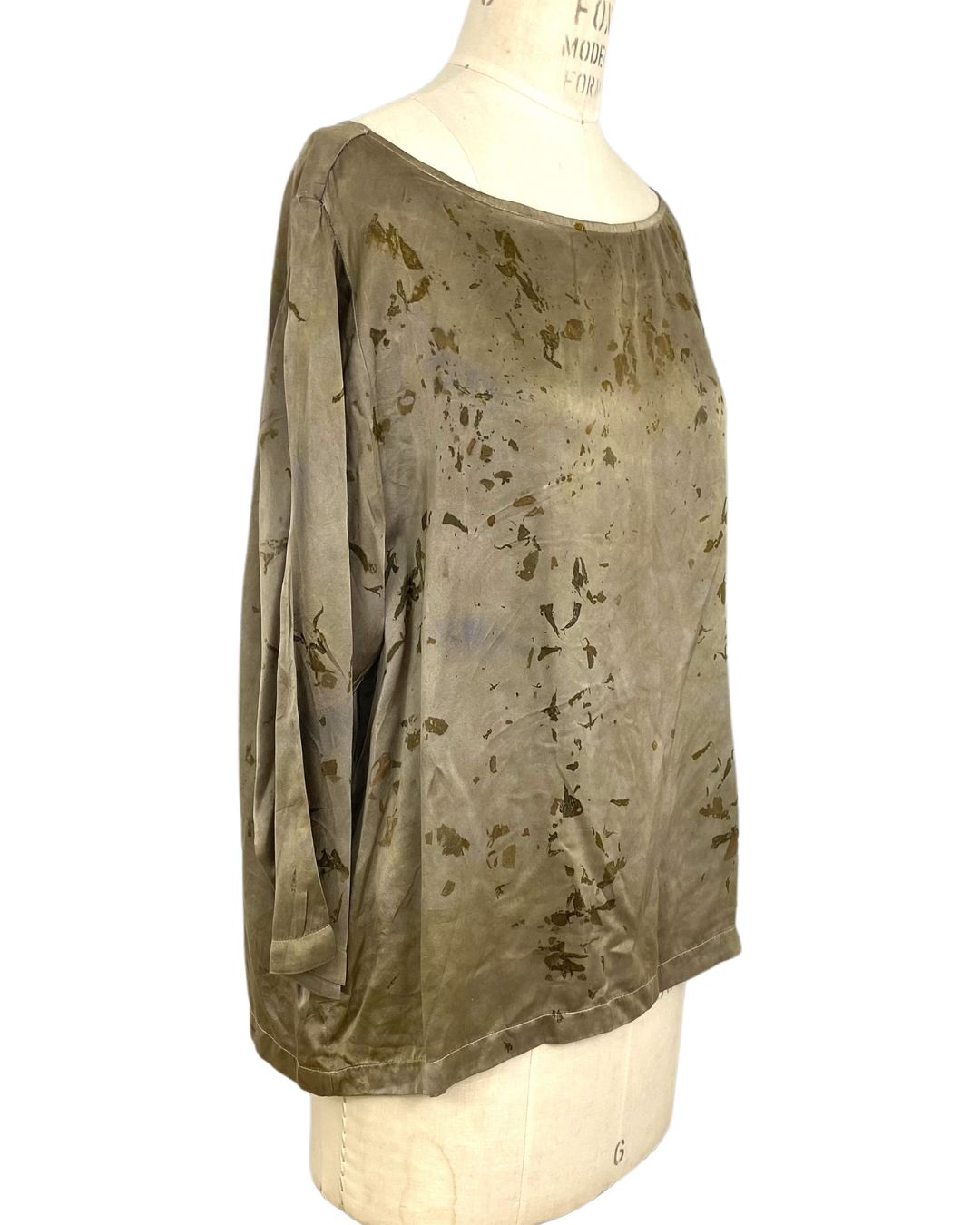 The olive green Lucia top naturally dyed floral print shown on a dress form, side view