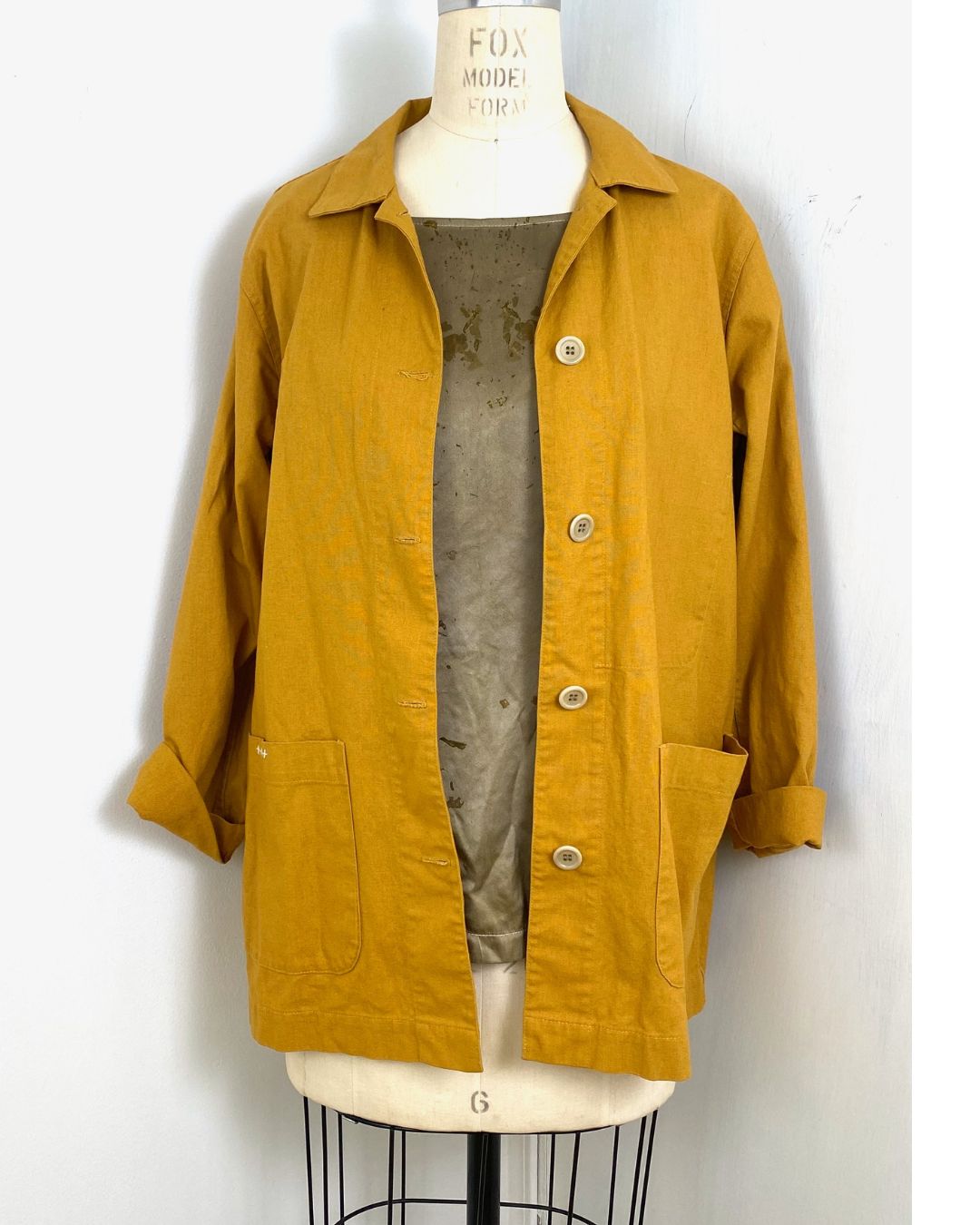 The olive green Lucia top naturally dyed floral print shown styled with a jacket and scarf