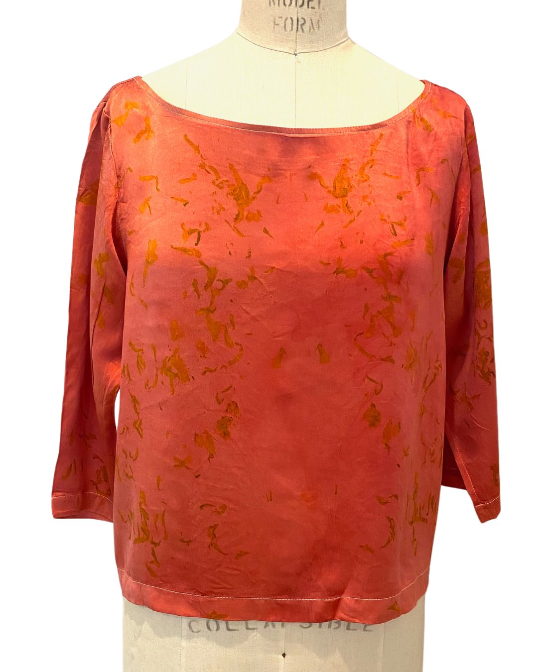 The red Lucia top naturally dyed floral print shown on a dress form, front view