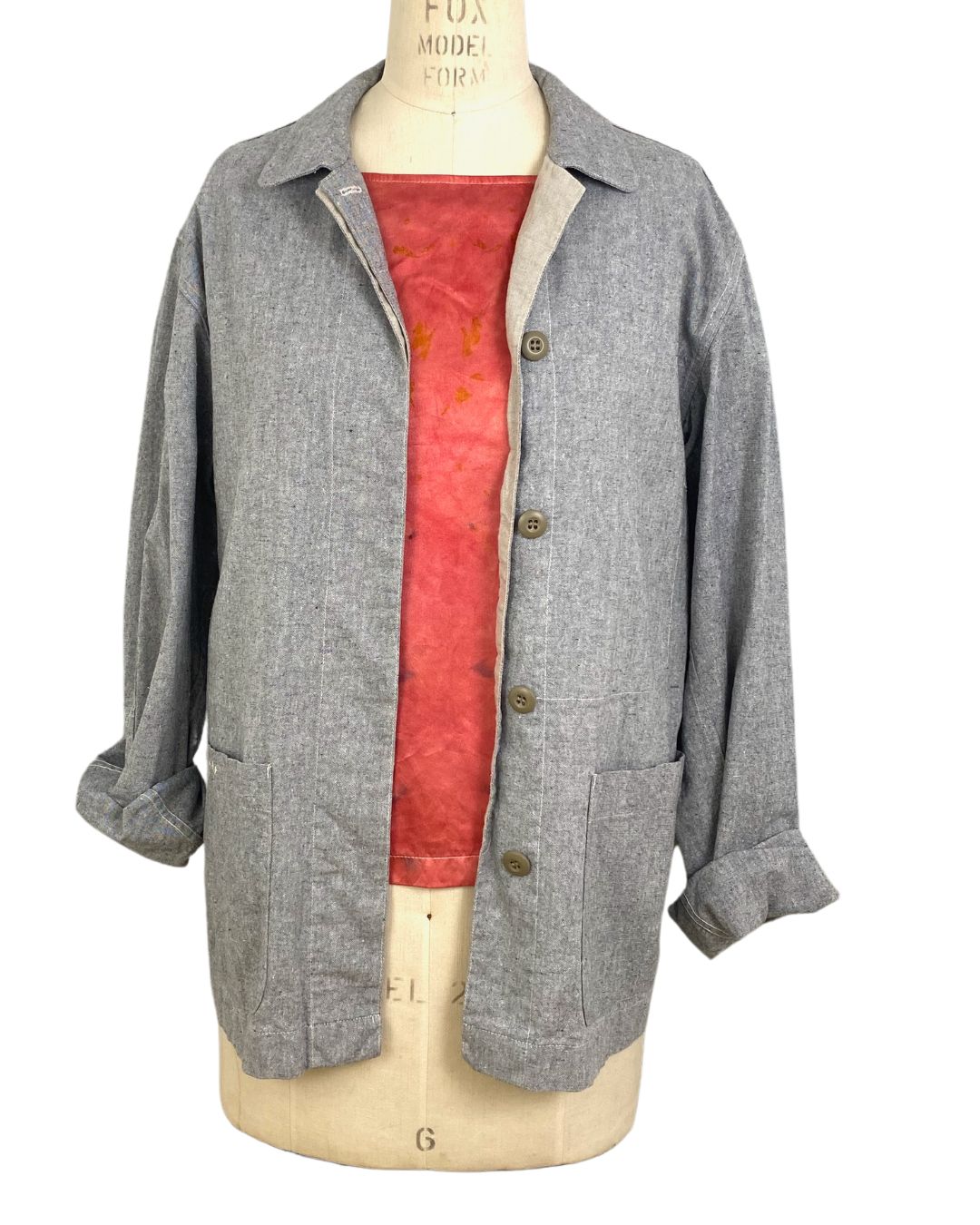 The red Lucia top naturally dyed floral print shown styled with a jacket and scarf