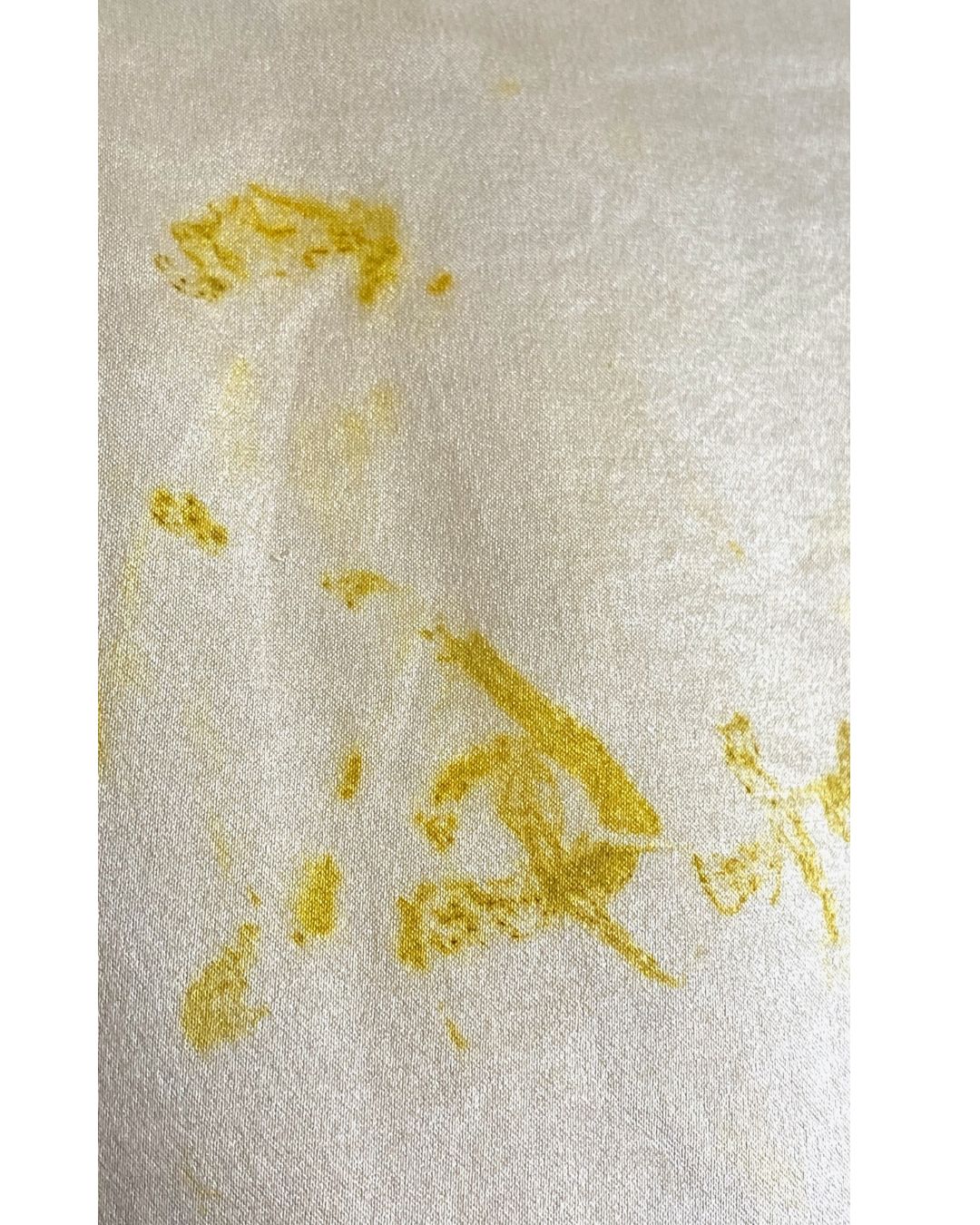 The yellow Lucia top naturally dyed floral print shown on a dress form, detail