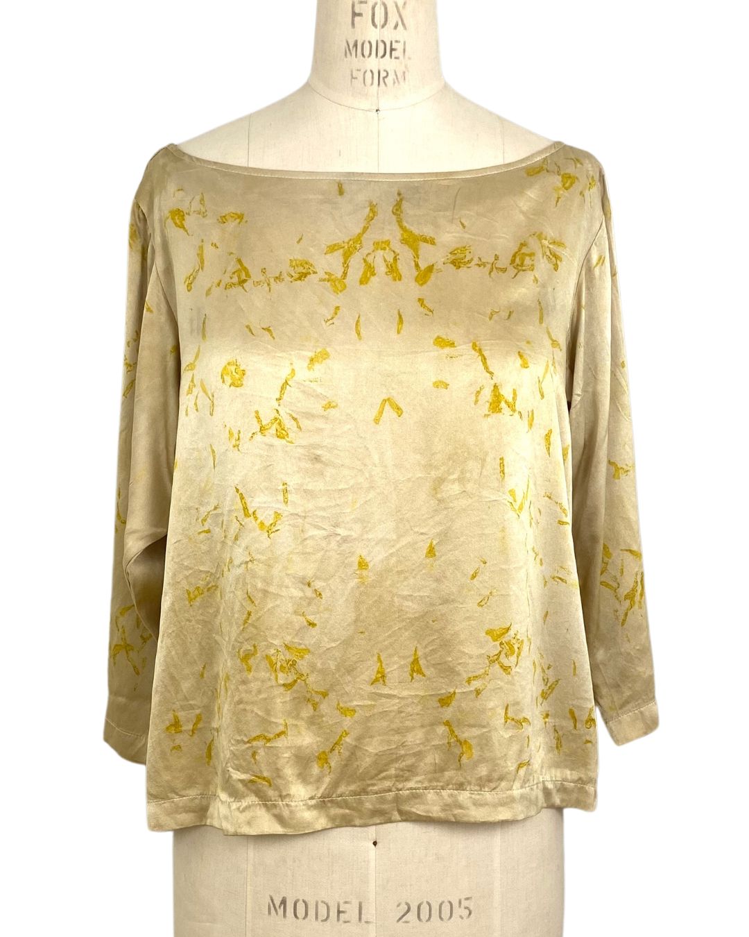 The yellow Lucia top naturally dyed floral print shown on a dress form, front view