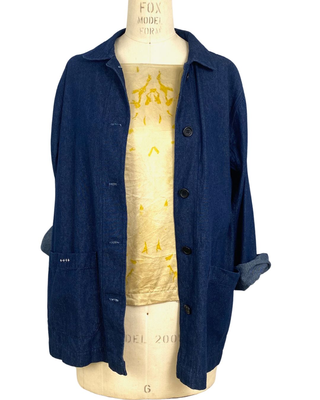 The yellow Lucia top naturally dyed floral print shown styled with a jacket and scarf