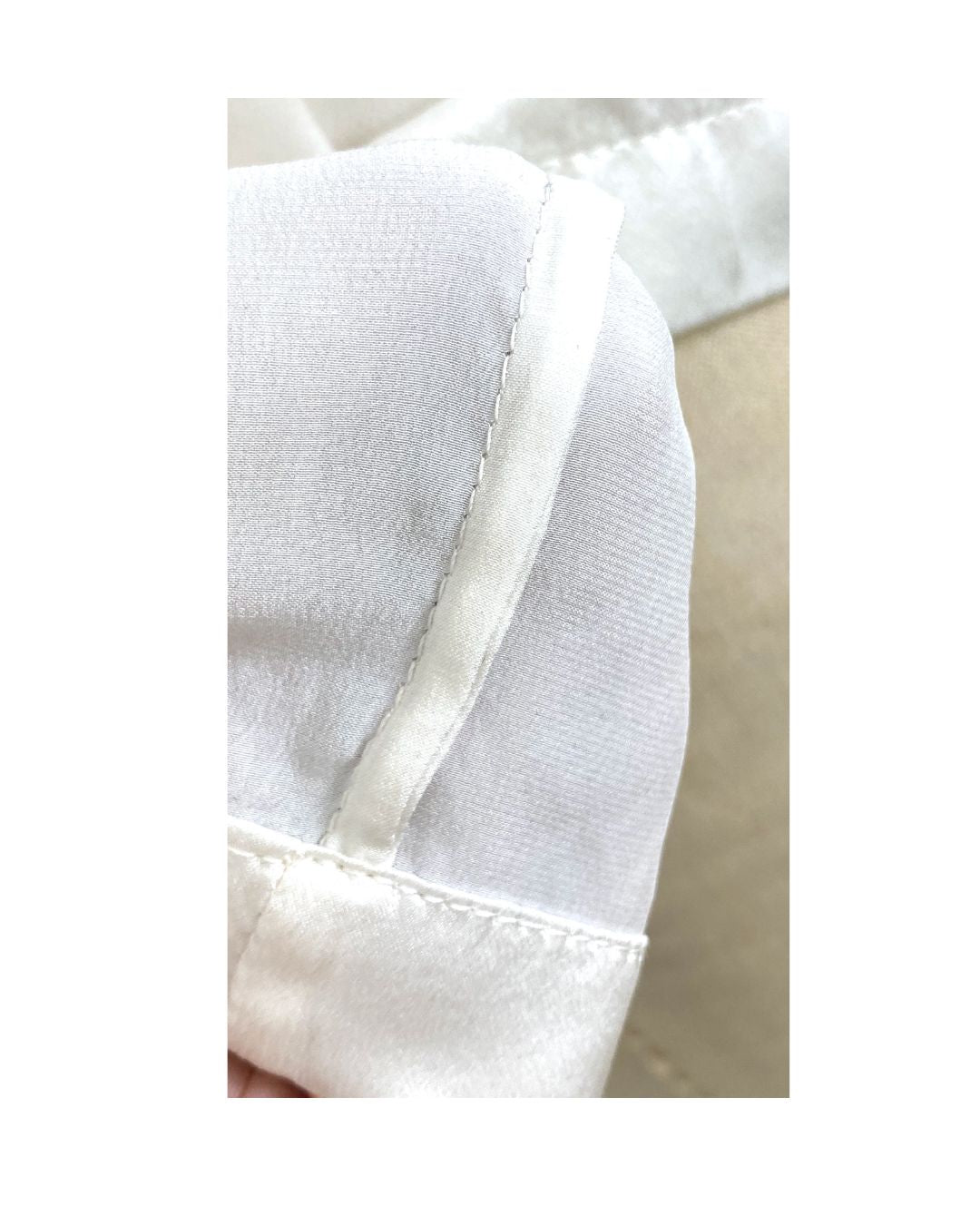 The white Lucia top shown styled, French seam detail