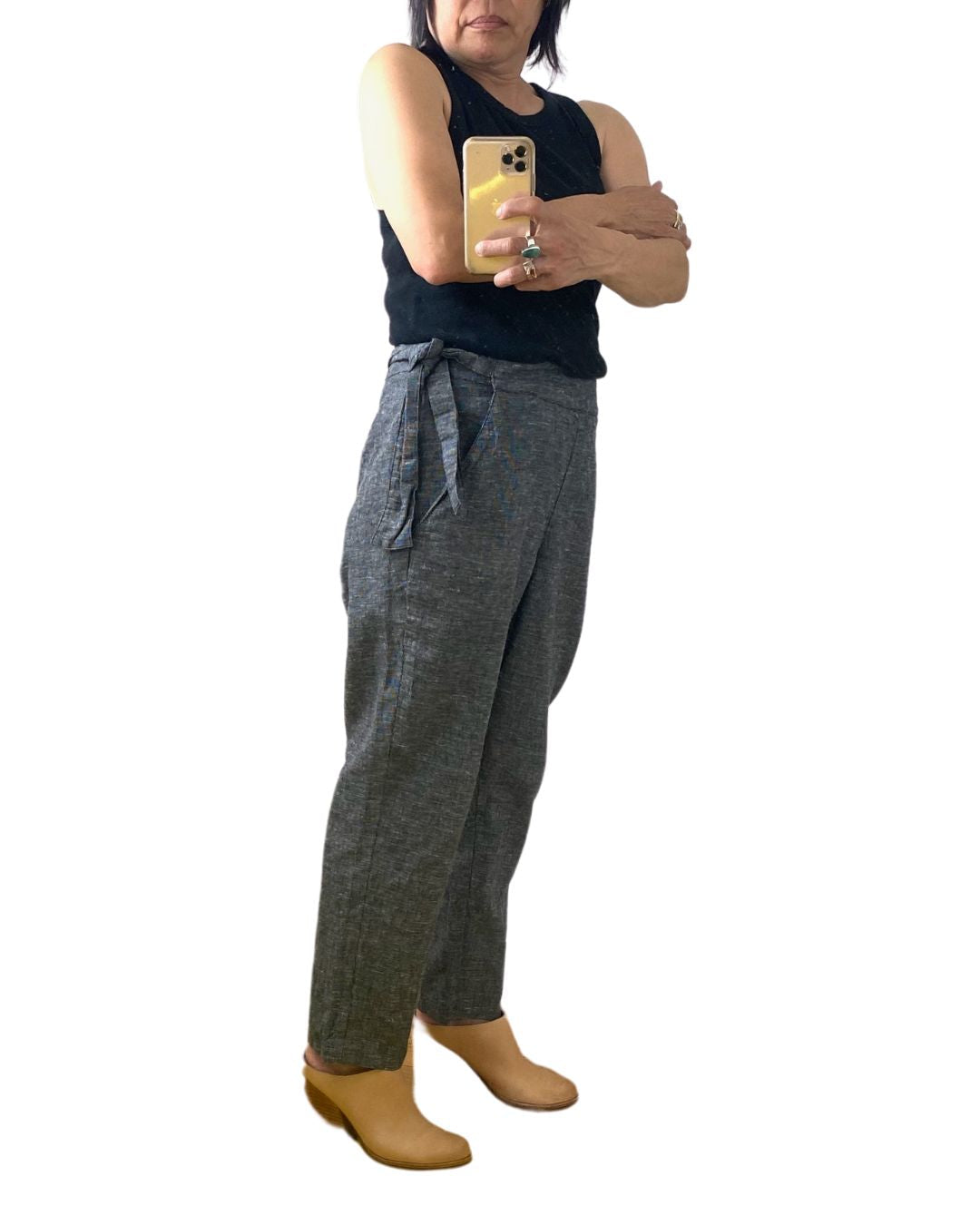 A woman wearing the black crop Nico pant, side view.