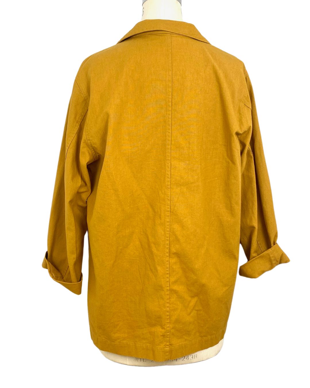 The sunrise jacket in yellow cotton linen fabric shown on a dress form, back view