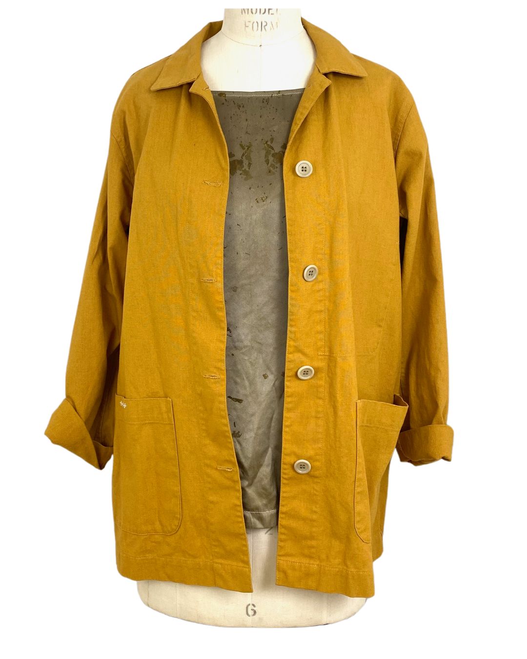 The sunrise jacket in yellow cotton linen fabric shown on a dress form, front view