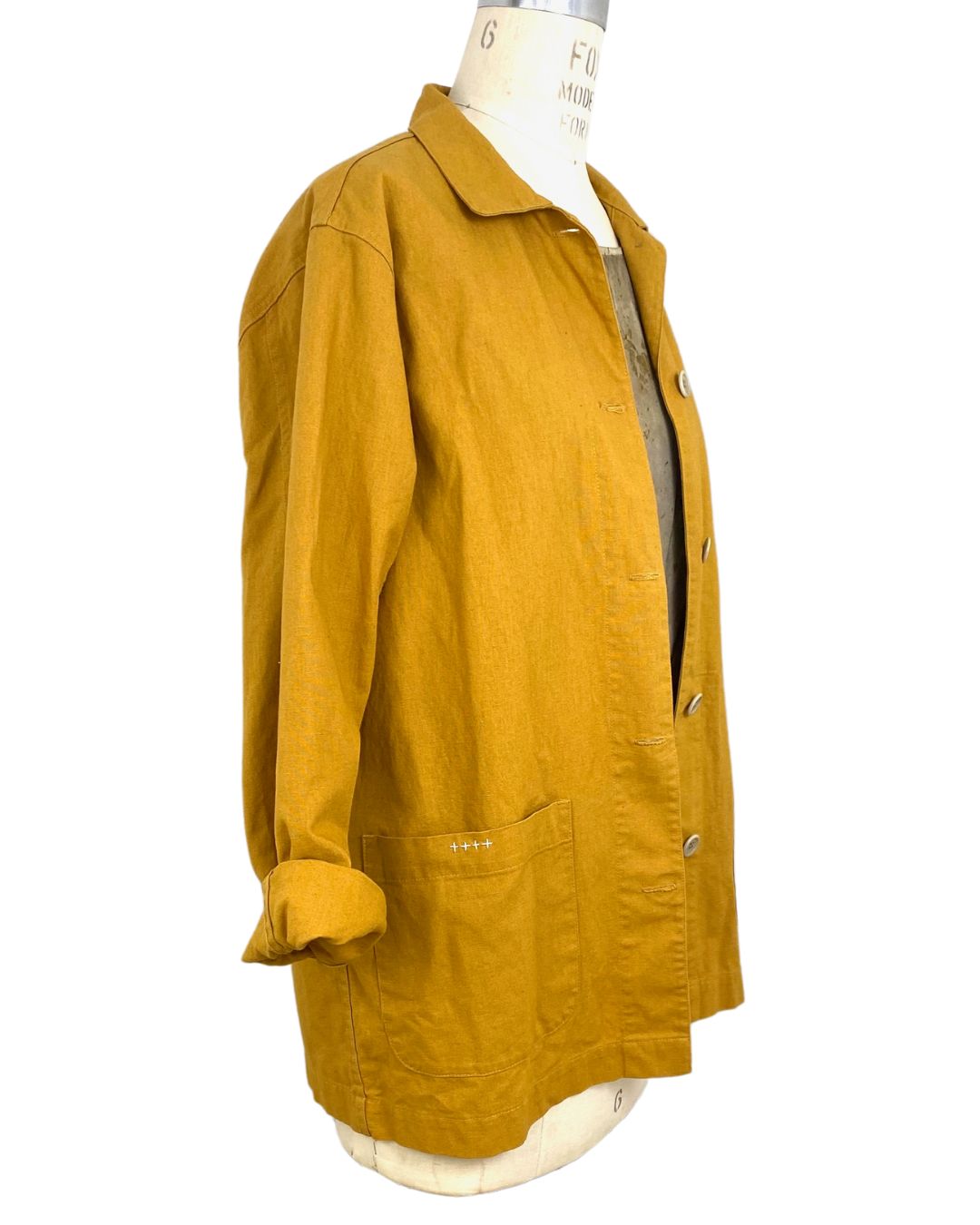 The sunrise jacket in yellow cotton linen fabric shown on a dress form, side view