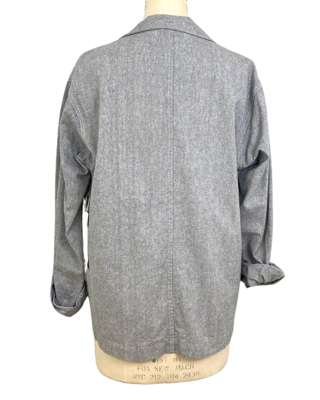The sunrise jacket in light grey organic cotton and hemp shown on a dress form, back view